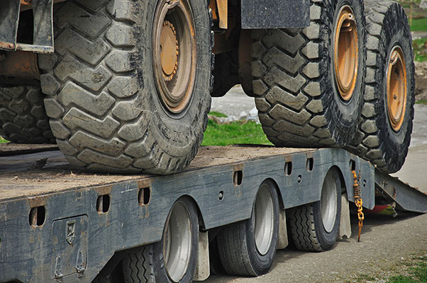 Machinery being loaded onto freight truck
